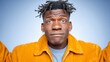 © BOJOShop - Close up portrait of a young Black man with dreadlocks and a confident expression