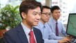 © BOJOShop - Three Asian businessmen in suits analyzing stock market data on computer screens office environment