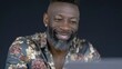 © BOJOShop - Mature Black man with grey beard smiling wearing a floral shirt close up studio portrait