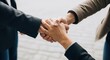 © GFX Corner - Three people shaking hands in a business agreement, symbolizing partnership and success