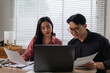© Phimwilai - Business colleagues analyzing financial data on laptop in office
