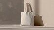 © Wida - Empty off-white tote bag against a neutral backdrop.