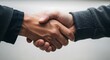© Pixel Stone - A firm handshake between two individuals, symbolizing agreement, trust, and the beginning of a successful partnership