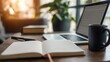 © min - Office desk scene: a white blank notebook and an open laptop placed on the desk, next to a black coffee cup, symbolizing work and creative inspiration in a modern minimalist workspace
