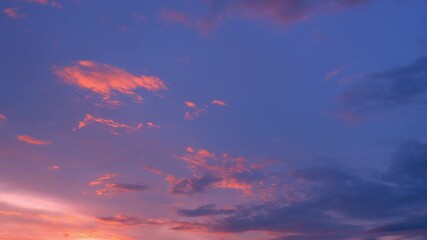 Wall Mural - A dynamic sunrise timelapse unveils a sky painted in deep purples and fiery orange clouds, shifting and glowing as dawn breaks, capturing the energy and ever-changing beauty of nature’s awakening.
