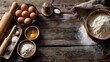 © Mrammon - A wooden table with a variety of ingredients for baking, including eggs, flour