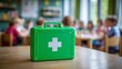 © Oleksandr - Classroom first aid: A bright green emergency kit sits on a table, ready for any mishaps in a room full of young children.