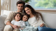 © Nataliya - Relaxing Latin family on sofa in soft sunlight living room