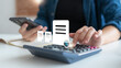 © K2L Family - Businesswoman calculating digital tax with calculator and smartphone, financial report and document icons, modern business accounting concept.