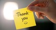 © Asfand - Hand holding a sticky note with 'Thank You' message, symbolizing gratitude and appreciation