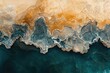© stockphoto02 - Abstract aerial view of teal and gold textured landscape, resembling an abstract painting of earth and water.