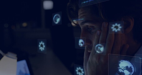 Resting man in dress shirt examining computer screen at office desk, with UI icons, copy space