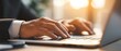 © jaya - Close-up of hands typing on a laptop.  Business professional at work