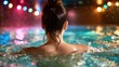 © JoxyAimages - A woman swims gracefully in a pool, back turned towards the camera, illuminated by colorful lights, encapsulating serenity and leisure in a beautiful and tranquil environment.