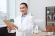 © New Africa - Doctor using tablet in clinic, space for text. Online medical consultation