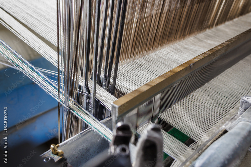 Warp and reed on modern weaving loom producing wool fabric Stock Photo ...