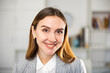 © JackF - Portrait of positive smiling businesswoman in suit looking at camera.
