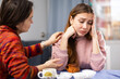 © JackF - Woman complains to her friend about life while sitting at a table with cups of tea