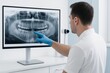 © Ekkarat_Studio - A dentist analyzes a digital dental X-ray on a large monitor providing expert insights for improved patient care.