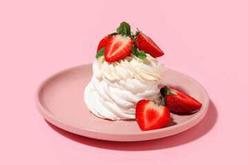 Wall Mural - Plate of sweet Pavlova cake with fresh strawberries and mint on pink background