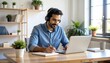 © NafiliaEmil - Focused 35s man sit at desk wear headphones watch webinar use laptop gain new knowledge writing notes. Video conference communication, negotiation remotely, study online. Detailed high quality image.