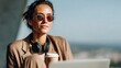 © kvladimirv - Woman Relaxing Outdoors with Sunglasses, Headphones, and Coffee