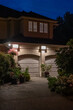 Garage door in luxury house with trees and nice landscape in Spring in Vancouver, Canada, North America. Night time on May 2025.