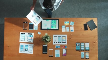 Top view of business man looking and choosing Ux Ui design at meeting room. Skilled developer designing and planning mobile phone interface or software application at creative workplace. Convocation.