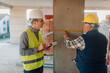 © Ljustina - Construction workers measuring wall with tape measure
