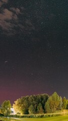 Wall Mural - Rural Countryside Night Sky Time Lapse. Amazing Starry Effects. Meteor Trails On Night Sky Background. Timelapse Night Sky Above River. Amazing Summer Landscape With Reflection In River. Star Lines