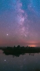 Wall Mural - Lake Nature Landscape. Night Starry Sky Milky Way Galaxy With Glowing Stars. Time Lapse Time-Lapse Nature Hyperlapse. Night Sky Reflection In Water