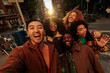© bernardbodo - Group of cheerful multiracial friends taking photo of themselves in Madrid