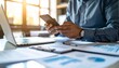 © 호균 최 - A person flipping through documents on a desk and checking their smartphone