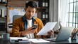 © 호균 최 - A person flipping through documents on a desk and checking their smartphone