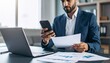 © 호균 최 - A person flipping through documents on a desk and checking their smartphone