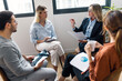 © BusinessClass by W61 - Mature businesswoman discussing ideas with colleagues sitting in office