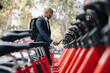 © BusinessClass by W61 - Businessman renting bicycle through smart phone at street