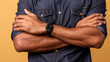 © buraratn - Person with crossed arms is wearing smartwatch, showcasing casual yet confident pose against warm yellow background. denim shirt adds relaxed vibe to overall appearance
