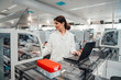 © BusinessClass by W61 - Scientist in modern laboratory analysing blood samples with laptop