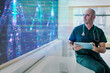 © BusinessClass by W61 - Doctor with tablet analyzing holographic anatomy screen in modern hospital