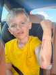 © Elena - Child in Backseat with Arm Injury and Bandage Display