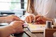 © standret - Planning the project, working. Close up view of young people sitting by the table indoors