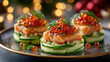 Three elegant salmon appetizers on cucumber slices, garnished with red caviar and dill. Christmas-themed background with festive lights and decorations.