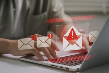 Person typing on laptop with phishing email warning alert,cyber threat prevention,online scam detection,communication security,malware protection,digital safety awareness concept