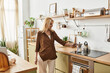 © LIGHTFIELD STUDIOS - Warm morning moments in a cozy kitchen with a senior beautiful woman preparing coffee
