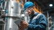 © Suriyo - Industrial quality control officer wearing helmet and safety glasses inspecting machinery with tablet in the plant test lab
