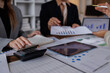 © David - Business people point to graphs and charts to analyze market data, balance sheet, account, net profit to plan new sales strategies to increase production capacity.