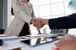 © David - Happy financial advisor Banker and client shaking hands after business loan grant.