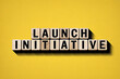 © Pixel Studio - Launch initiative concept wooden blocks on yellow background for business strategy and development plan