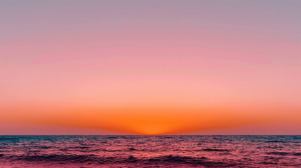 Wall Mural - Serene sunset over ocean creates beautiful gradient of pink and orange hues in sky, reflecting softly on water surface, evoking sense of calm and tranquility